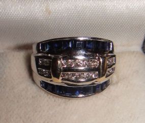 One stamped 10KT white and yellow gold lady's cast diamond and sapphire ring