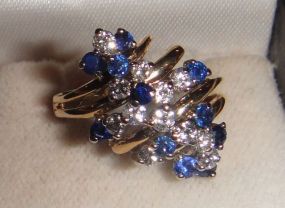 One stamped 14KT yellow gold lady's cast sapphire and diamond waterfall ring