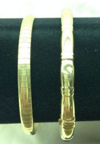 Two Stamped 14K Yellow Gold Lady's Bangle Bracelets with Bright Polish Finish.